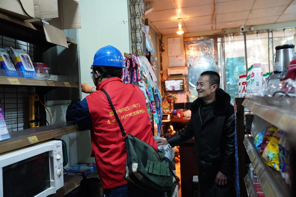 共产党员服务队维修店内接线故障。（苟华彬 摄）
