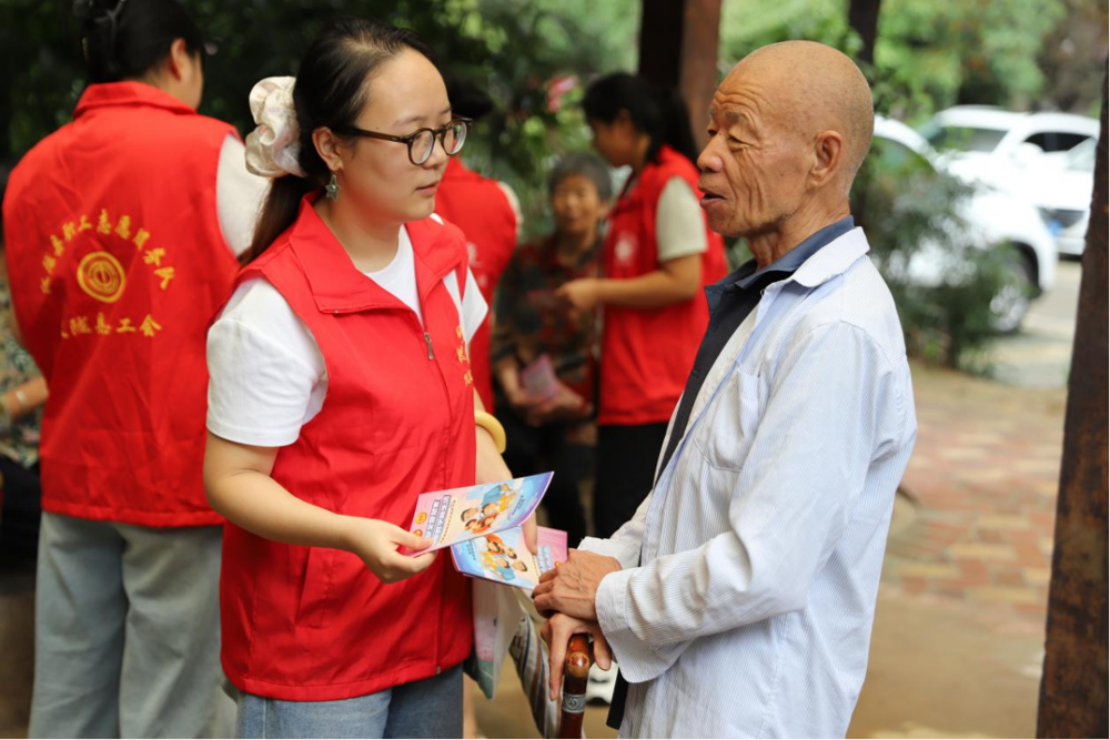 图为普法志愿者给居民讲解法律知识