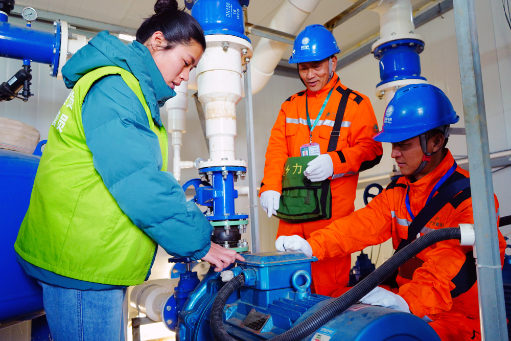 电力工人在示范基地检查喷灌设备设施